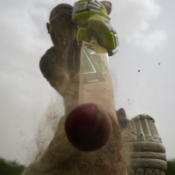 Person hitting a cricket ball