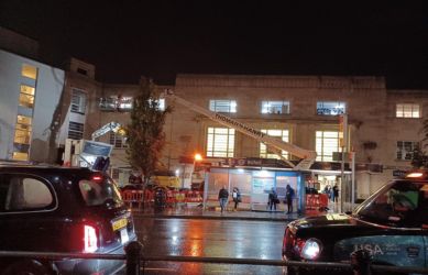 The stone cleaning process at Richmond station in action at night - South Western Railway
