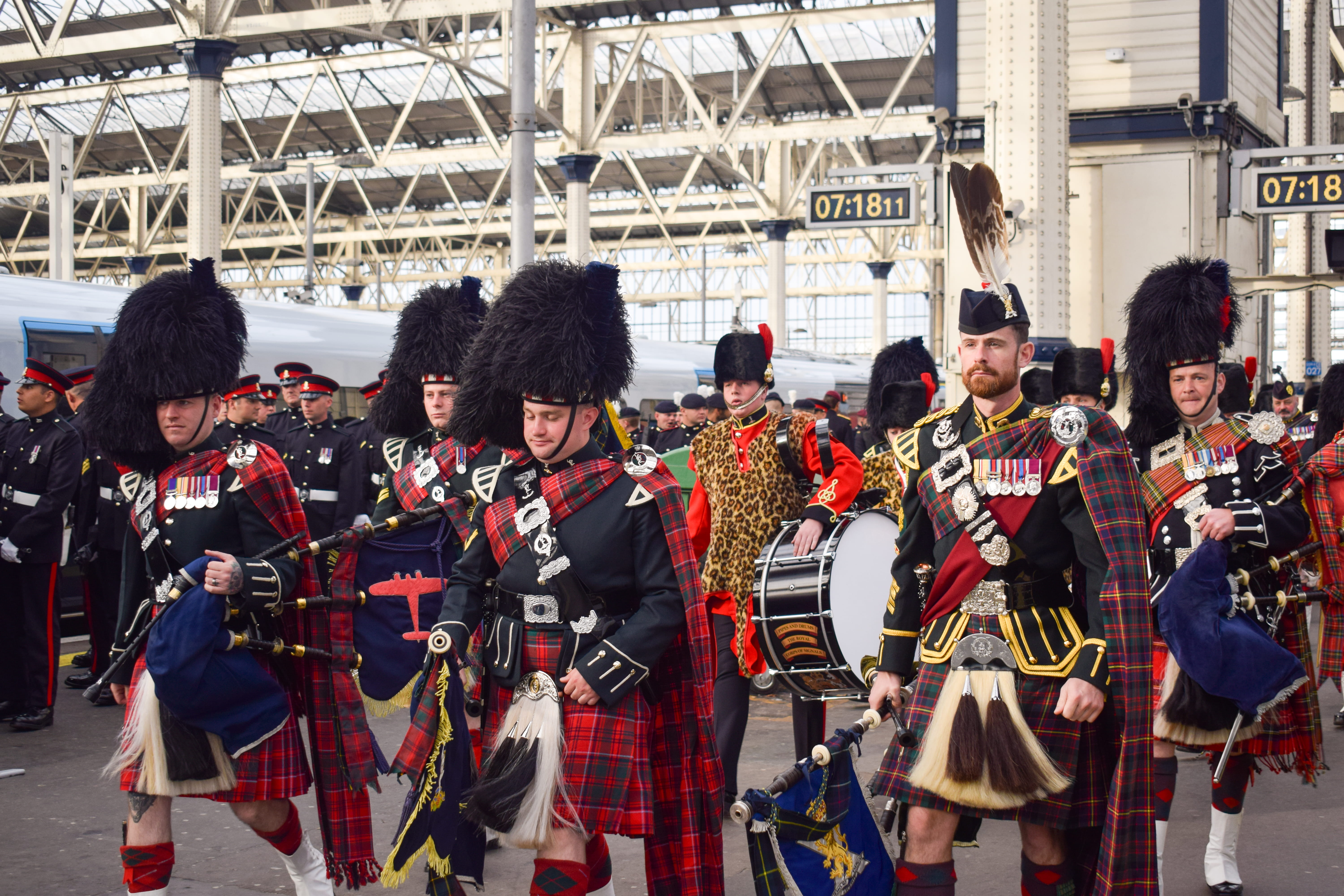 Pipers and drummers from a Scots regimental band on the platform at Waterloo