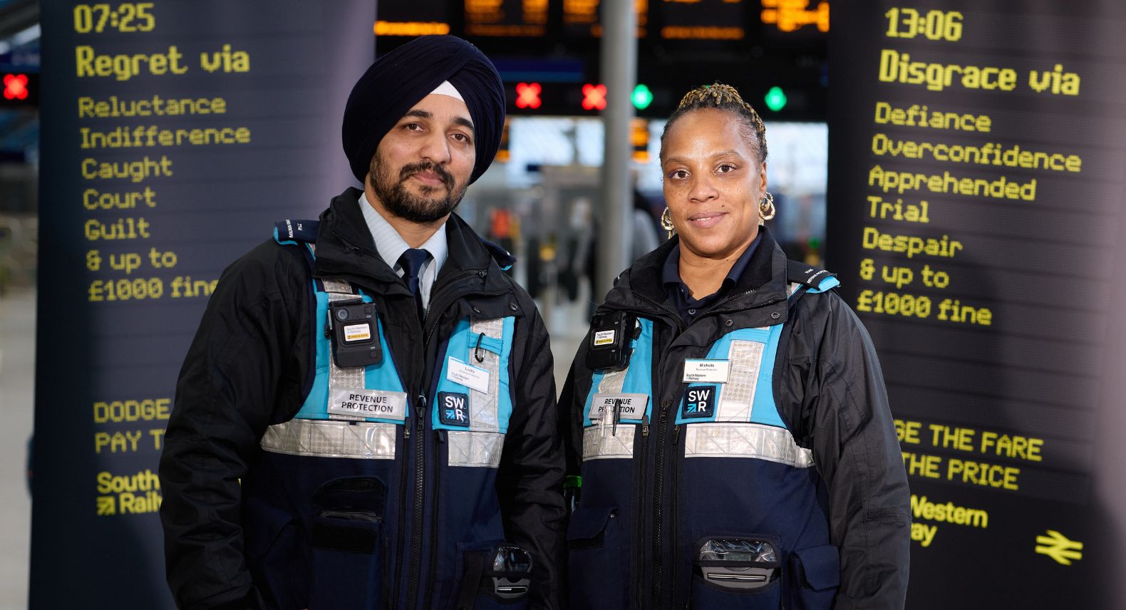Two people in uniform standing between two banners