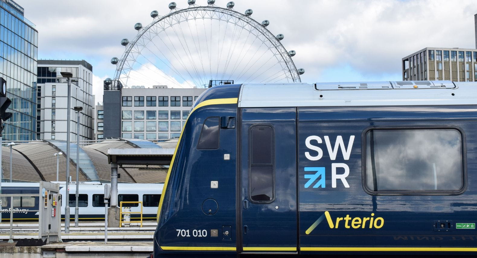 Sideview of Arterio train at Waterloo platform with the London Eye in the background