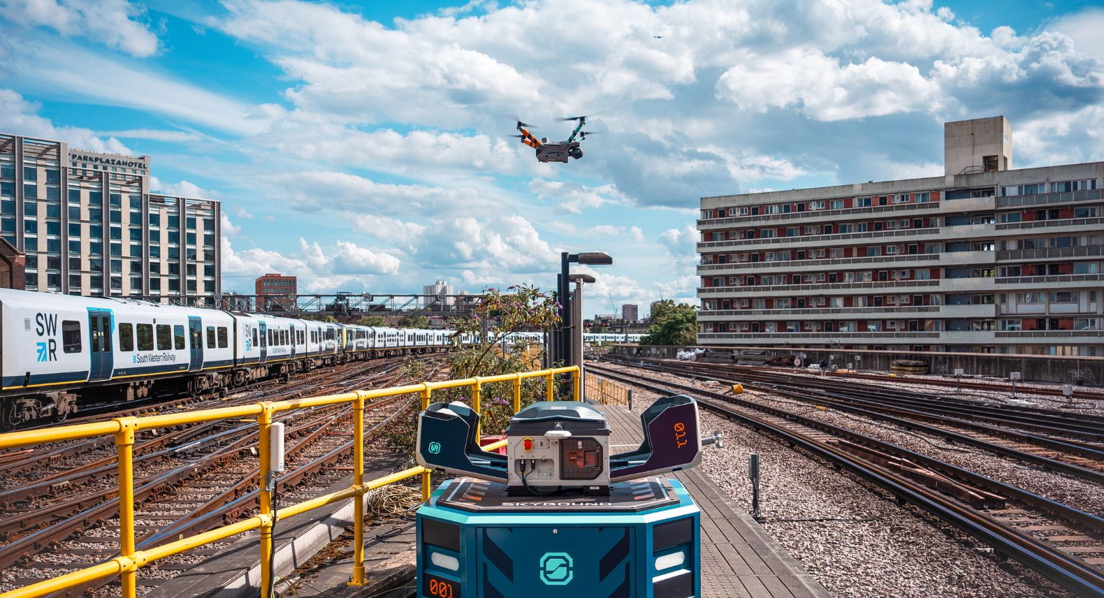 Drone hovering above railway tracks outside Waterloo station