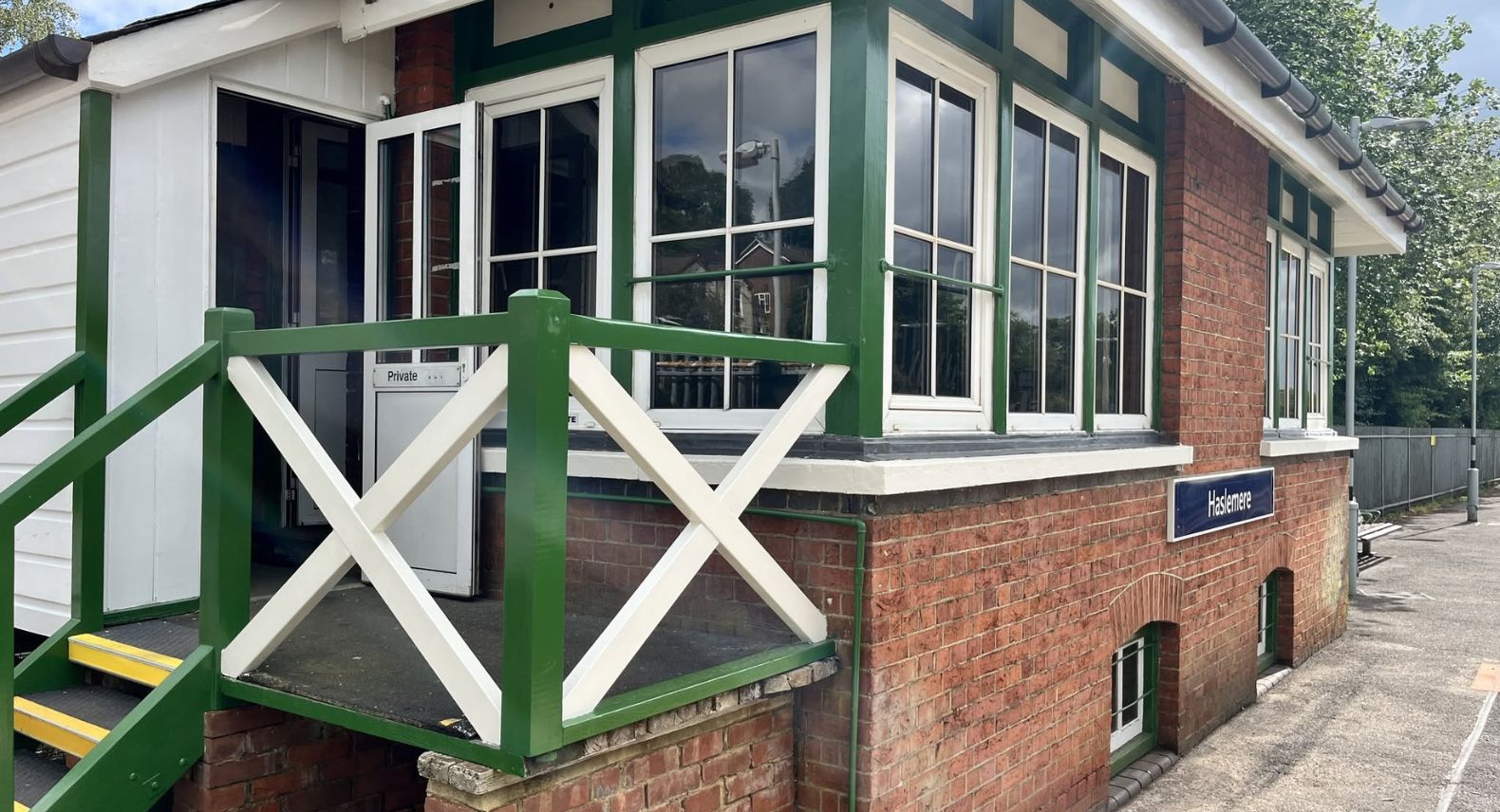 Exterior view of an old railway signal box on Haslemere station platform