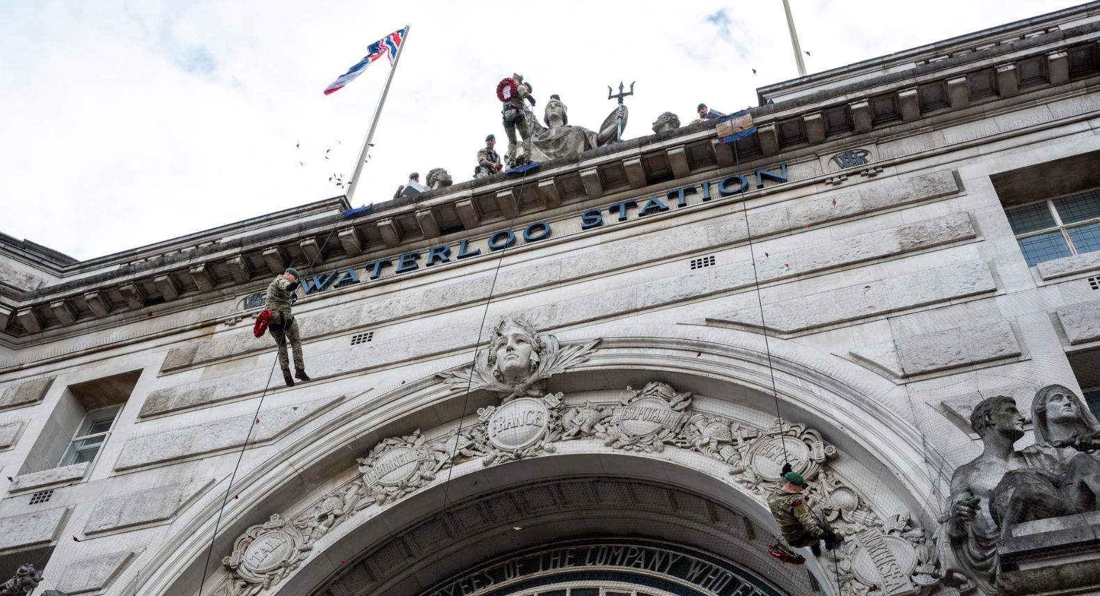 A Royal Marine abseiling from London Waterloo's iconic Victory Arch.