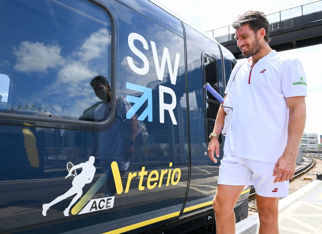 Tennis star Cameron Norrie smiling at the 'Ace train' a South Western Railway Arterio