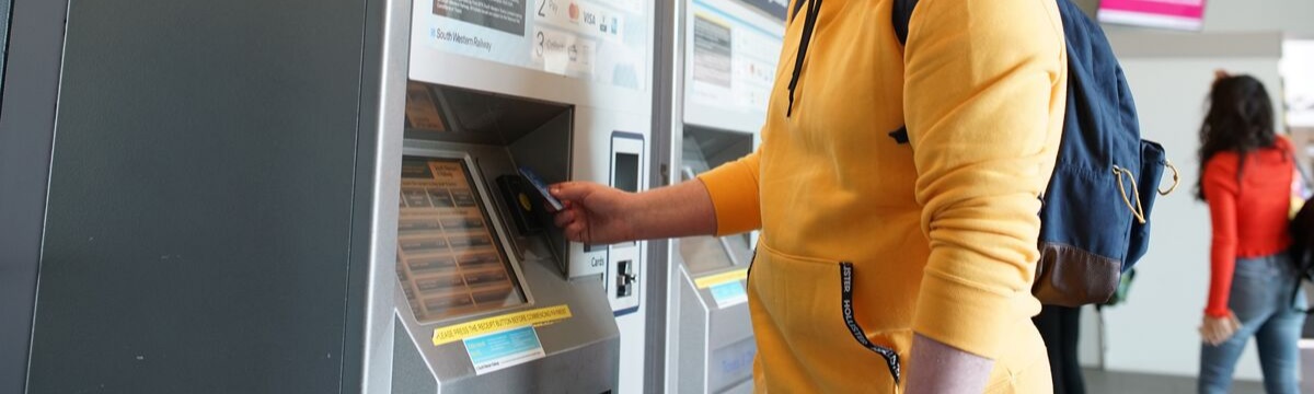 Man buying ticket from self-service machine
