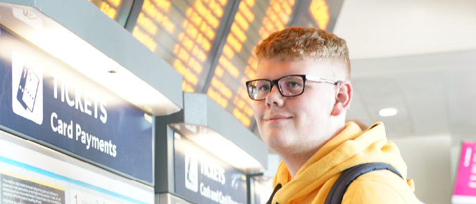 young men in front of ticket machine at the train station