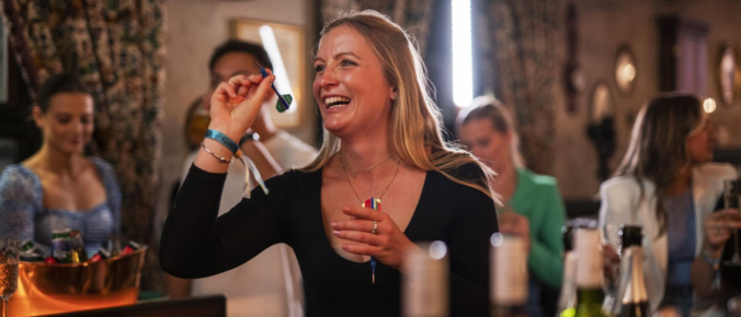 woman play darts in a pub