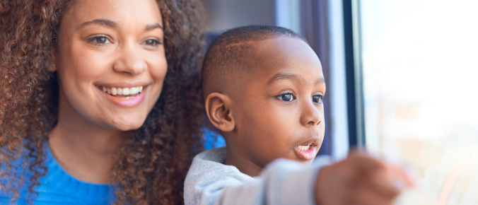 kids enjoy the train ride with his mum