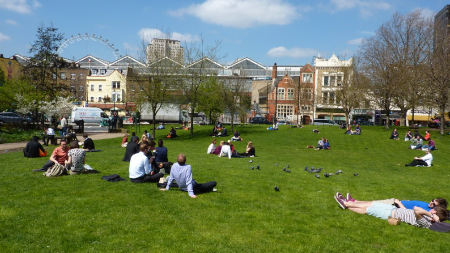 People sat on the grass at Waterloo Millennium Green park