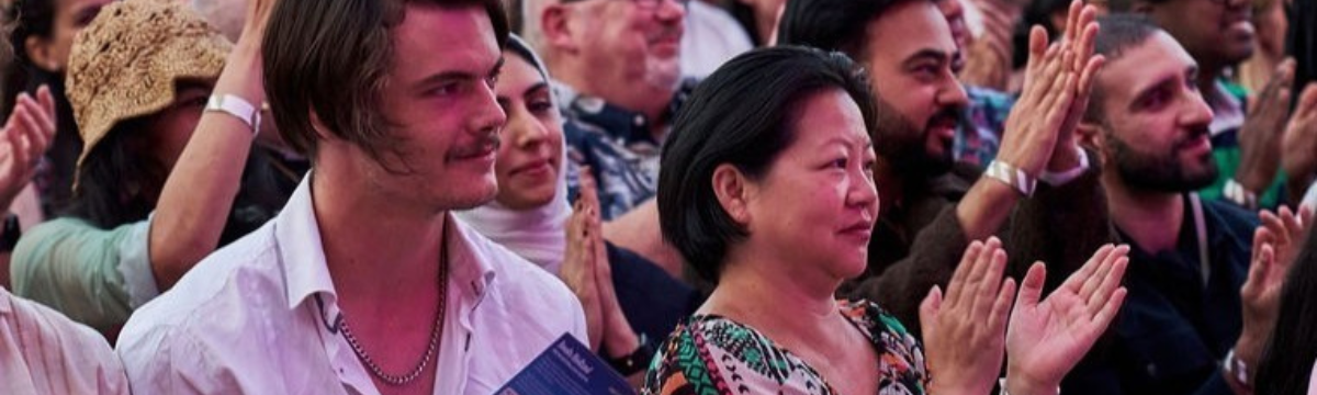 Festival audience clapping during comedy show