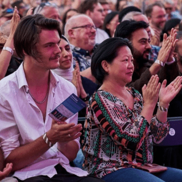 Festival audience clapping during comedy show