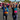 Runners celebrating mid‑race, holding hands and raising arms in excitement.
