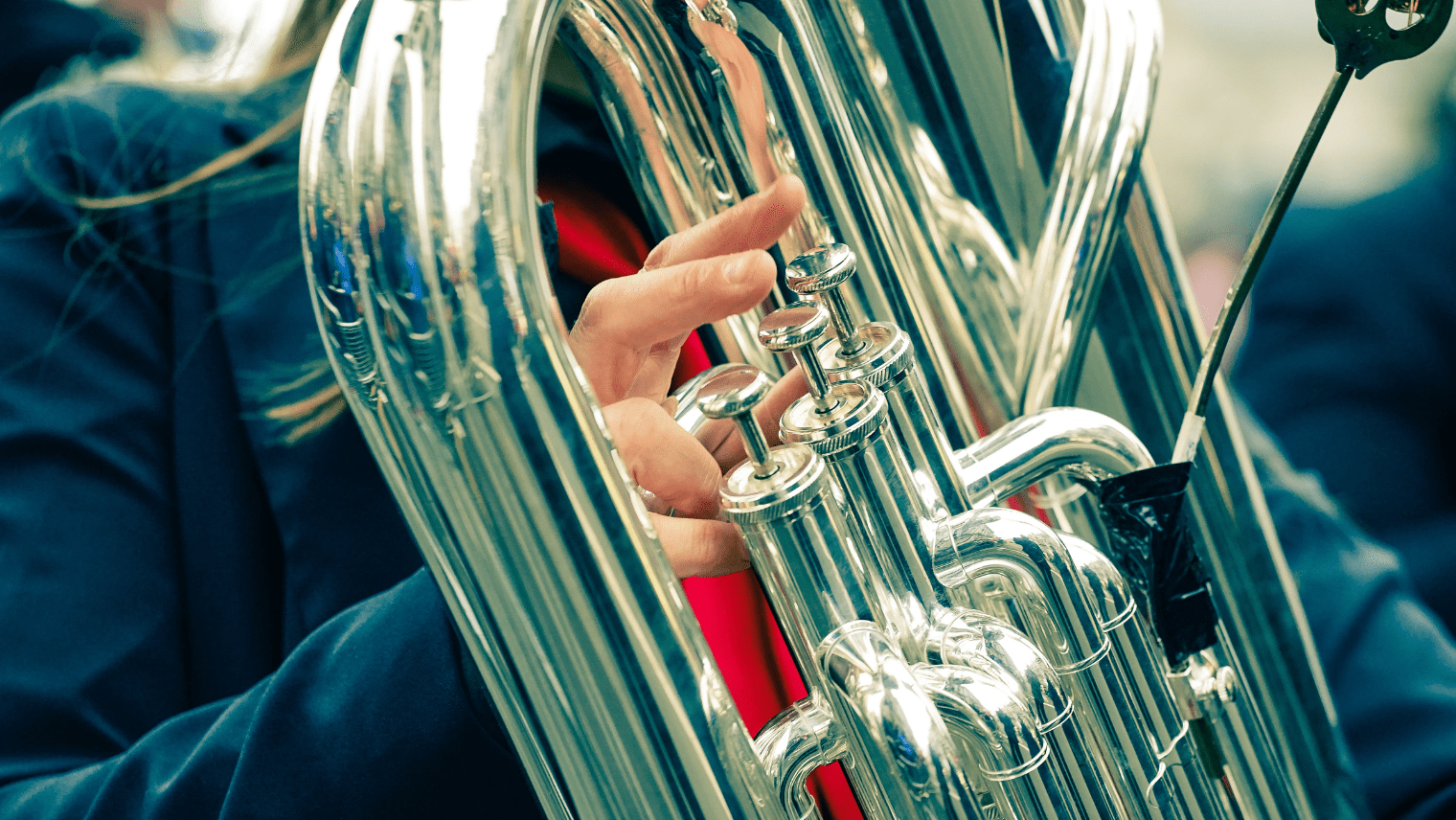 A person playing a brass instrument at a parade