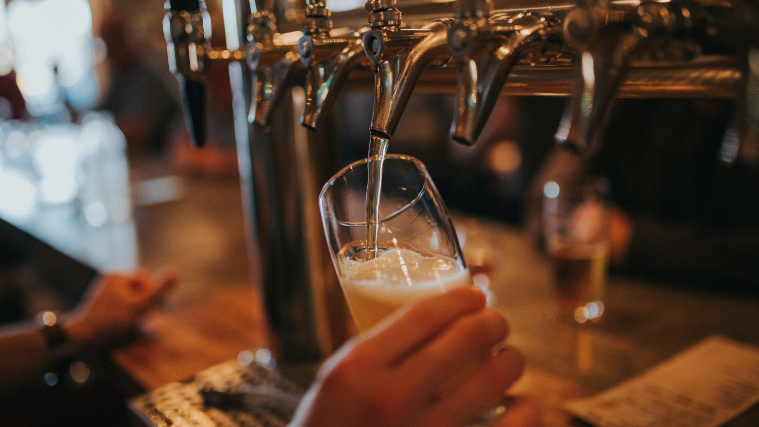 Image of a person pouring a pint at a pub