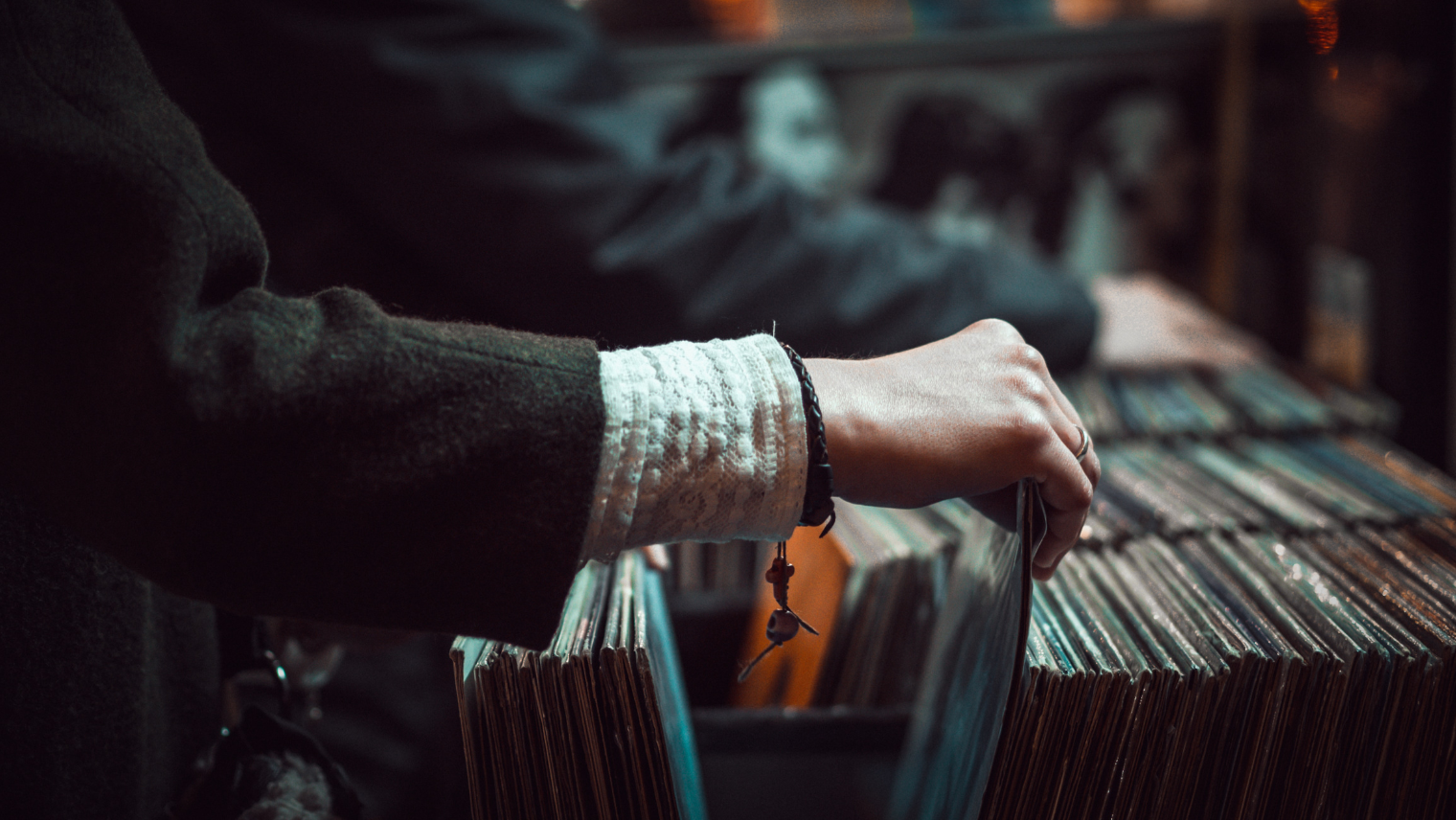 Image of people scrolling through records at a record store