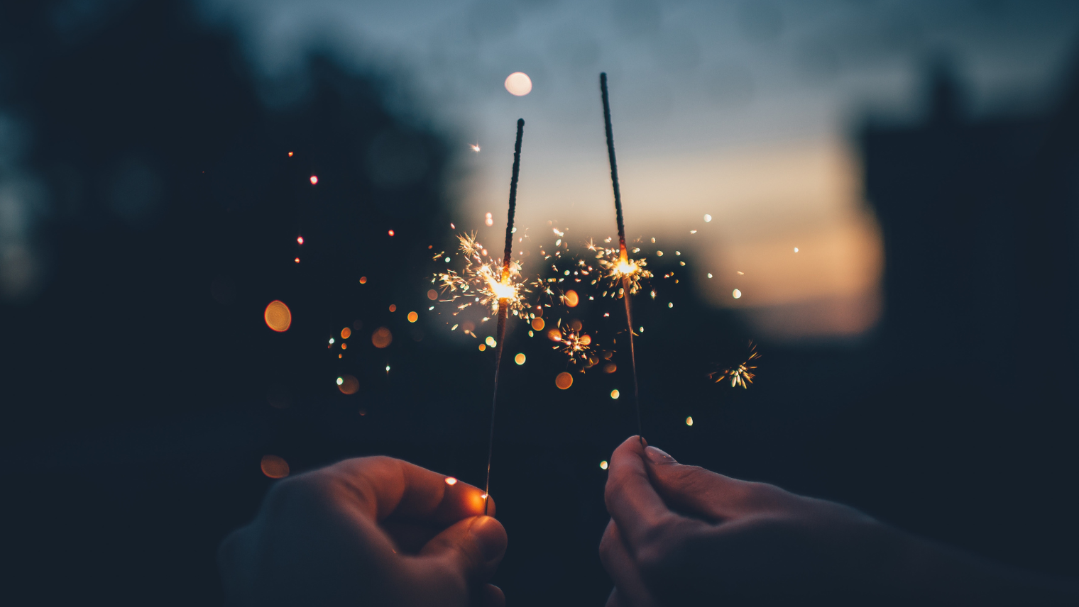 2 people holding sparklers