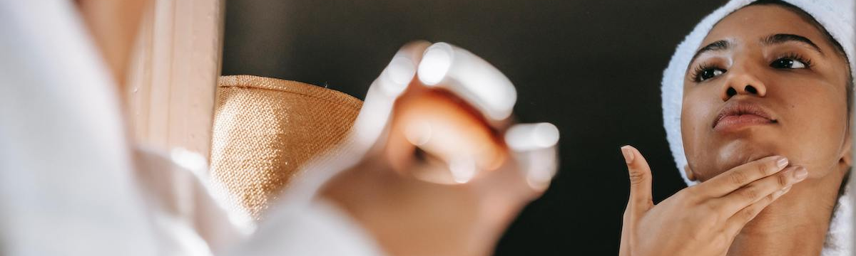 she take care of herself by applying cream on her face