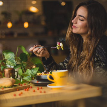Girl eating in healthy reastaurant