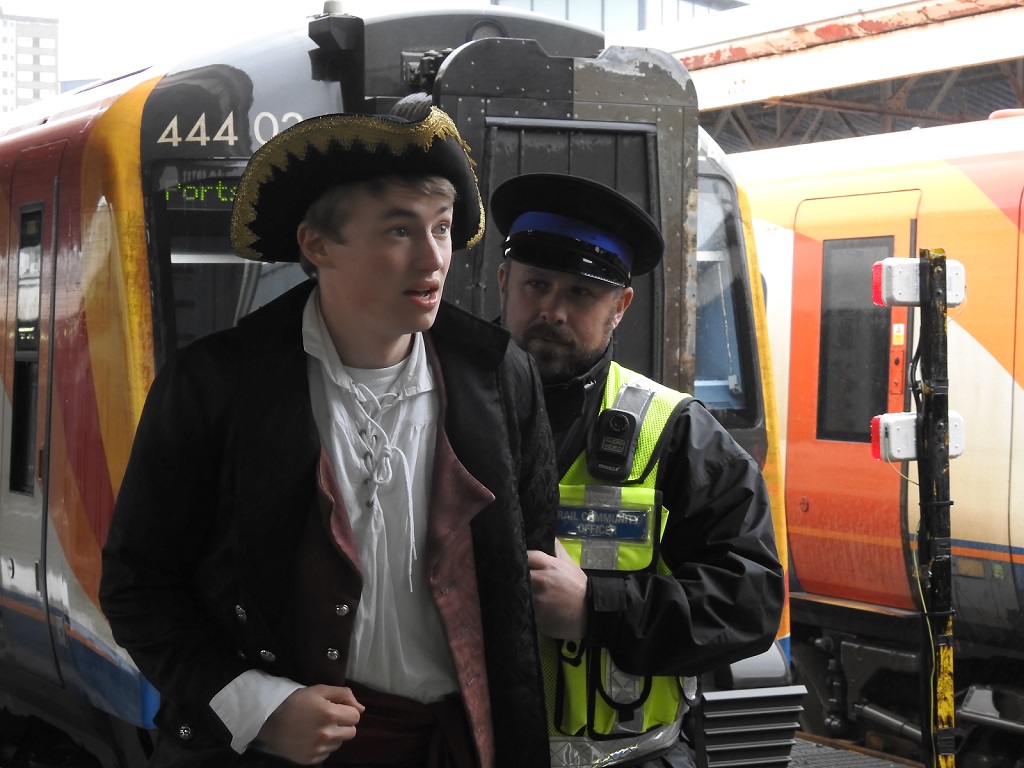 A pirate is apprehended by a Rail Community Officer at a South Western Railway station
