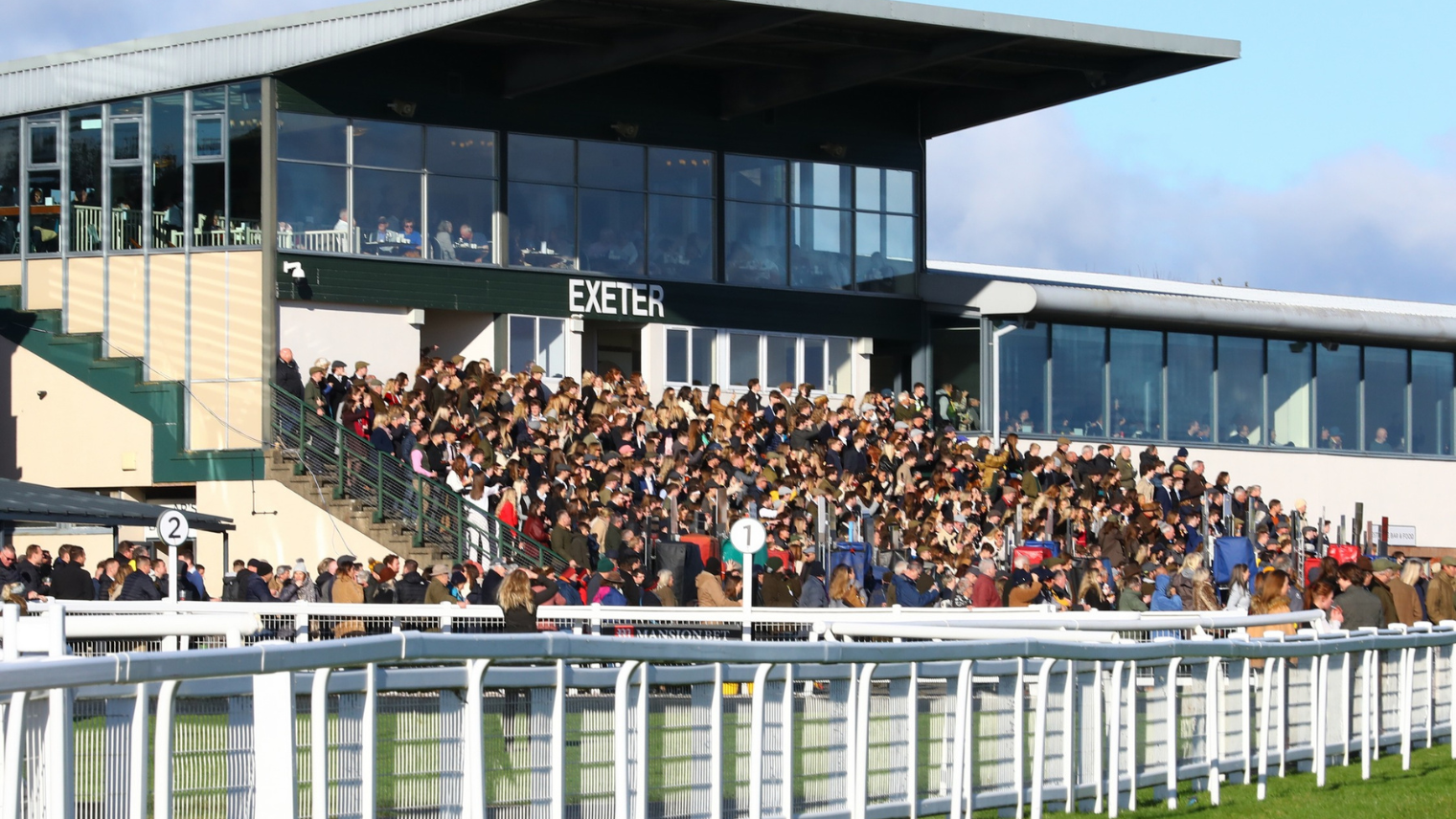 Spectators sitting in the stands at Exeter Racecourse 