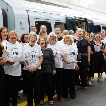 A group picture in front of a train