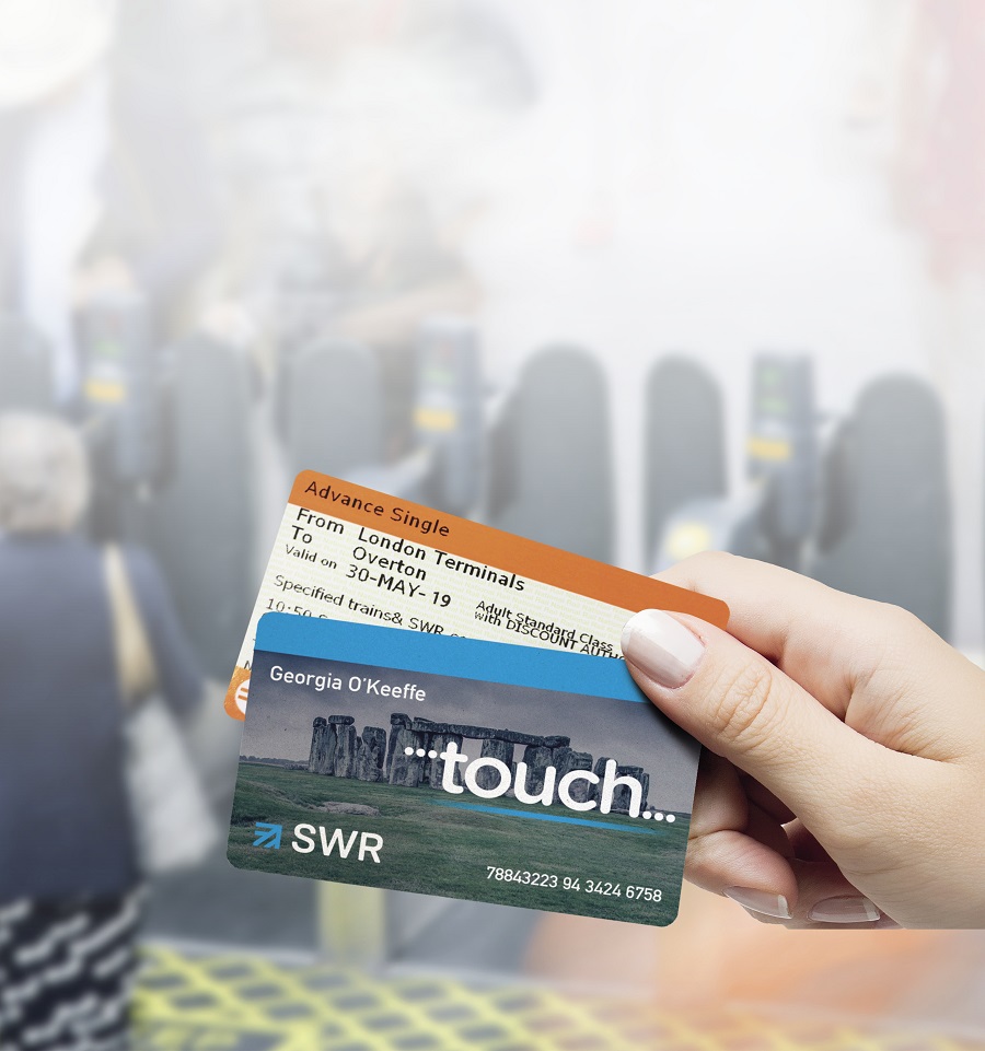 A hand holding an advance ticket and a Touch smart card