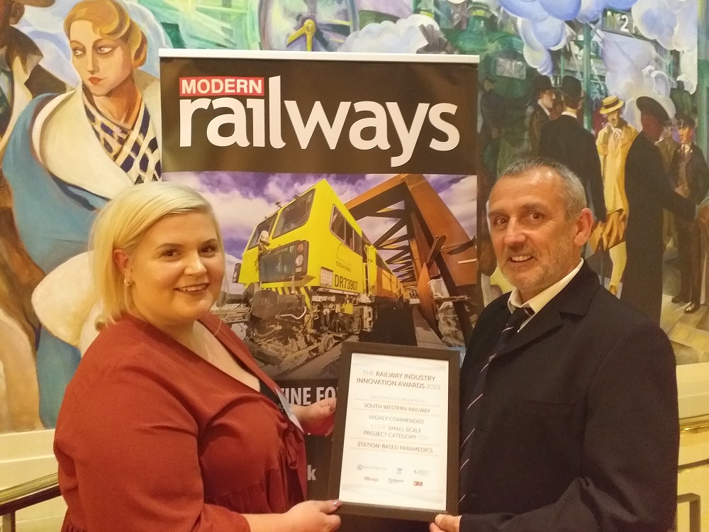 Chris Eason and Samantha Price hold their award