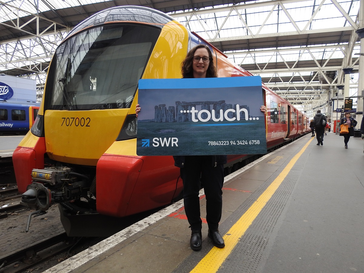Fiona Whyte, March winner of the Renew Without the Queue Annual Season ticket prize, holding a novelty oversize smartcard