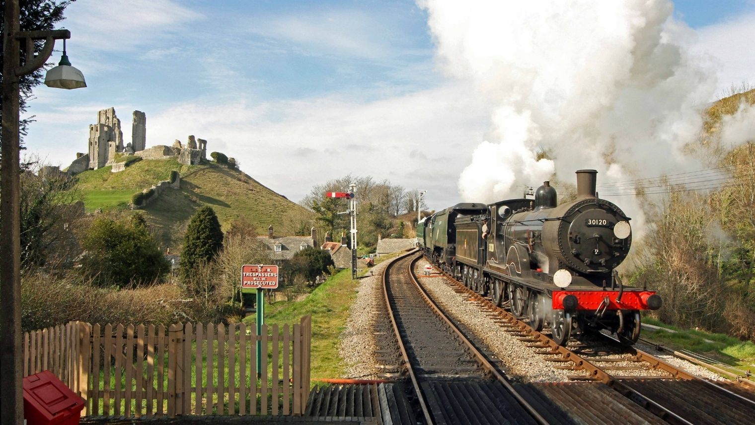 A steam train arriving at Corfe Castle station