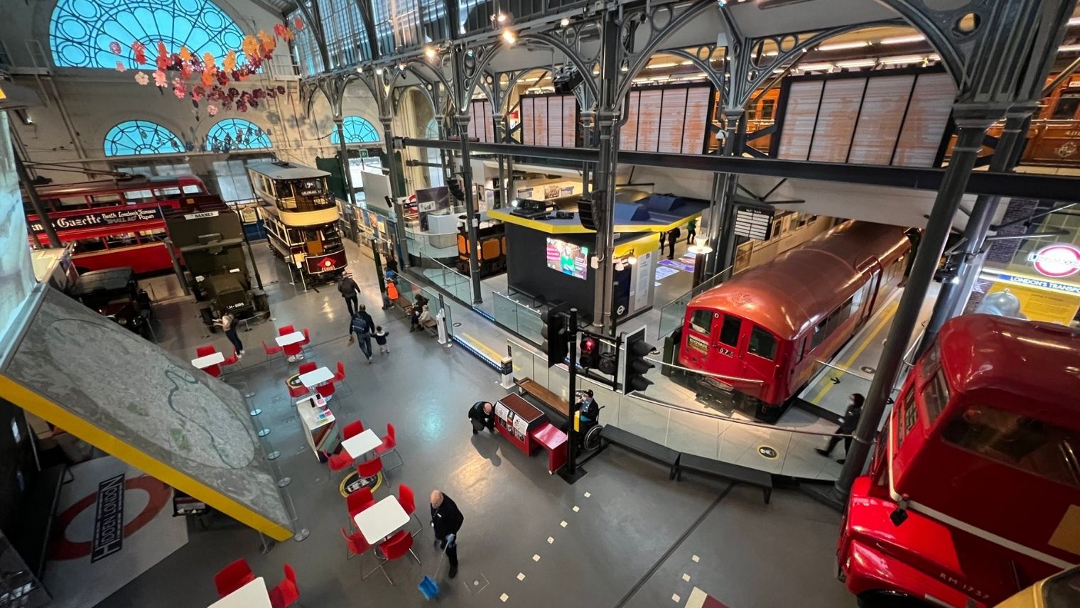 A view from a balcony of the London Transport Museum showing buses and a tube train