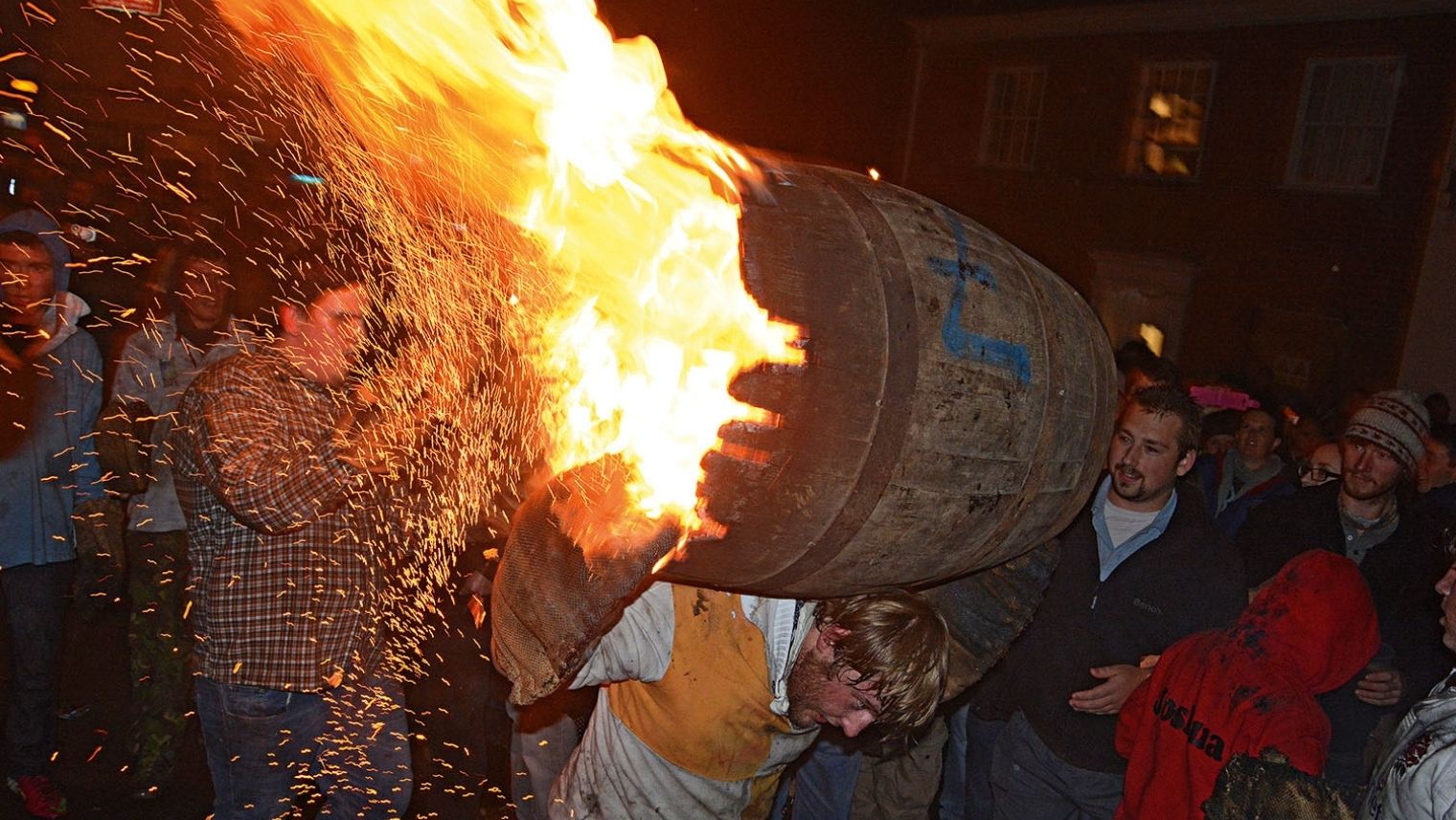 Flaming tar barrel being carried at the Ottery St Mary Tar Barrels