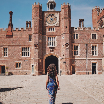 Woman walking towards Hampton Court Palace