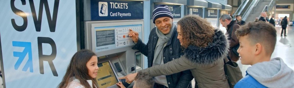 Family buying ticket for South Western Railway at a ticket vending machine